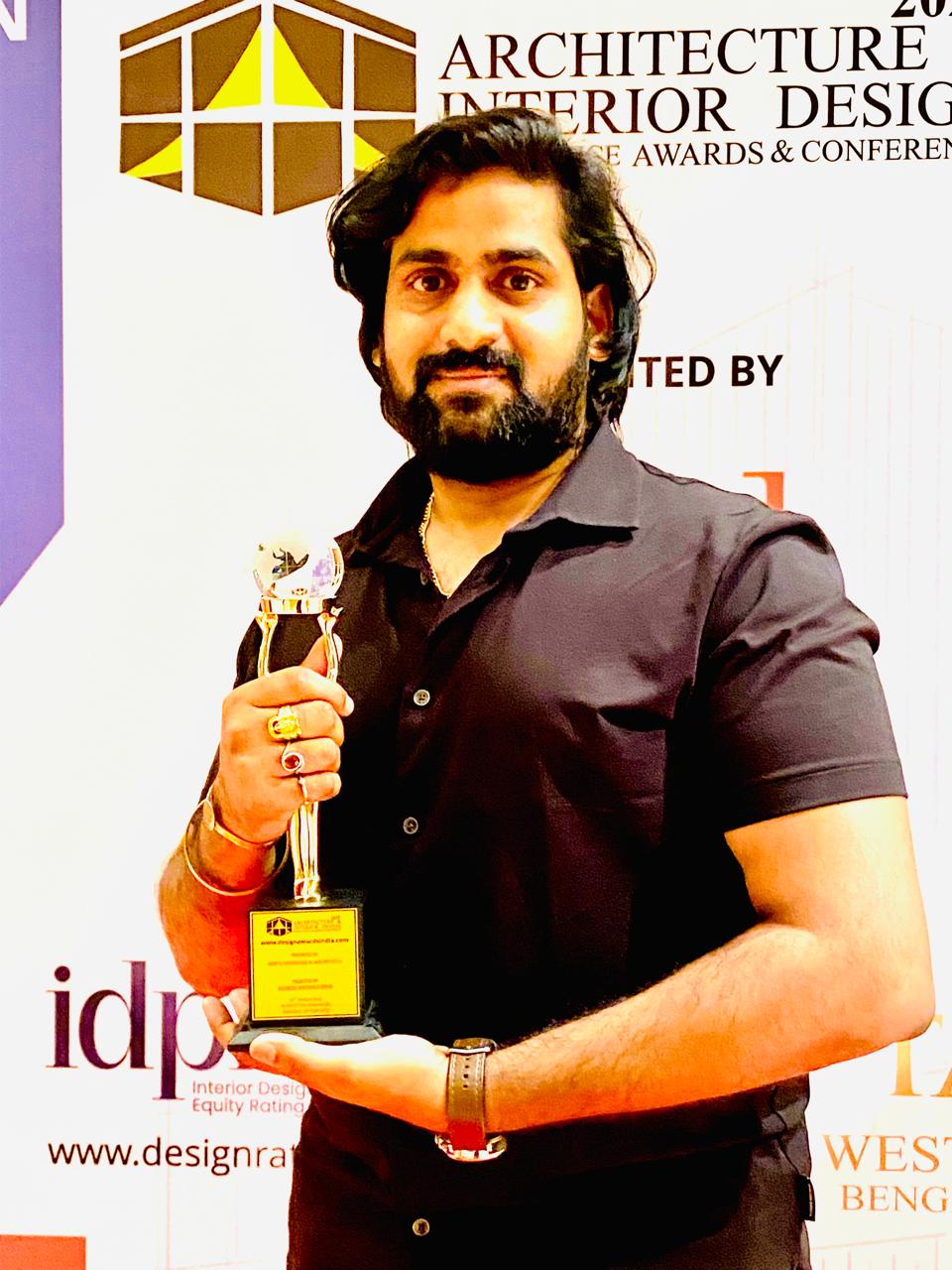 Mr. Santosh Kumar holding the Best Designer Award trophy